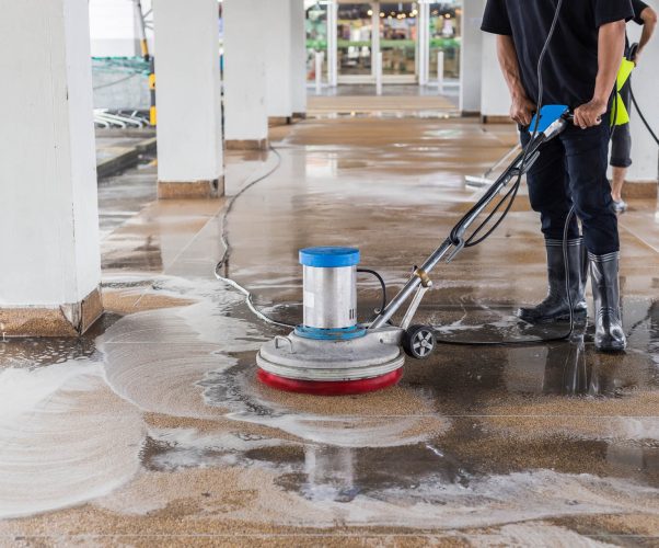 asian-worker-cleaning-sand-wash-exterior-walkway